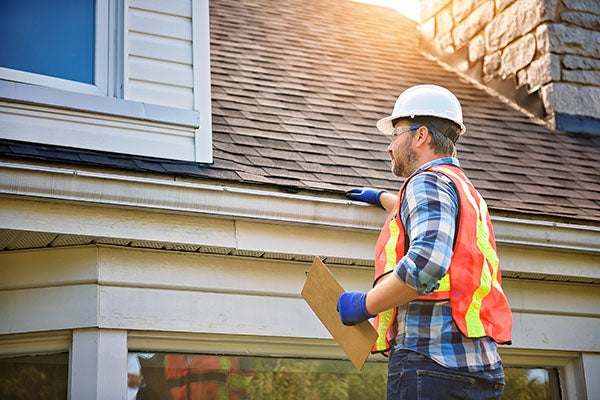 A man inspecting a house